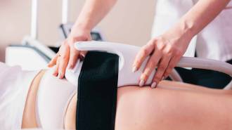 Woman getting ems treatment on buttocks to burn fat, build muscles and remove cellulite. Professional beauty salon